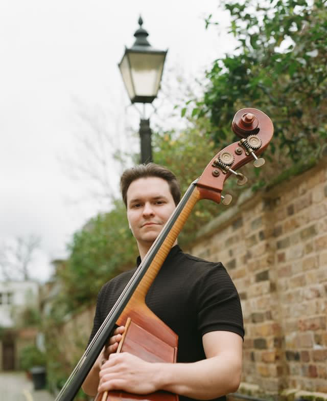 Daniil with double bass outdoors